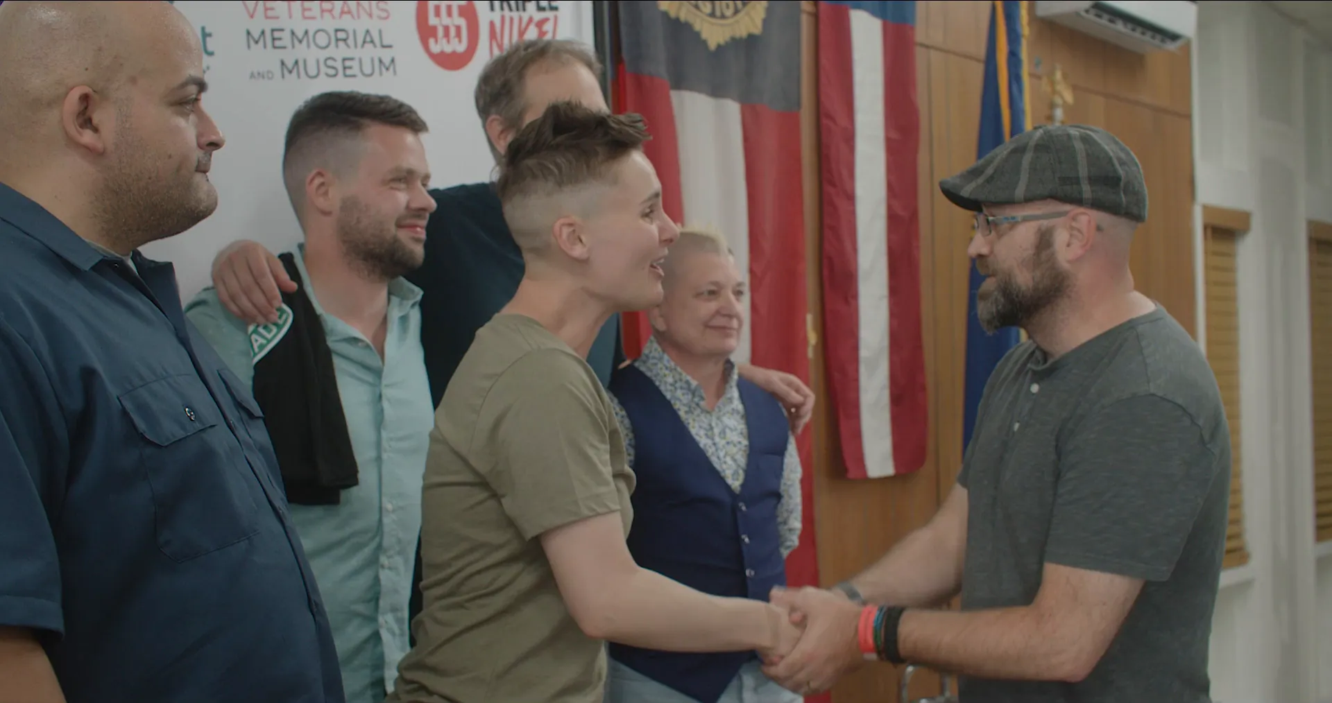 Veterans shake hands and share a laugh at the American Legion Alamo Post 2 Operation Heal*arious comedy show.