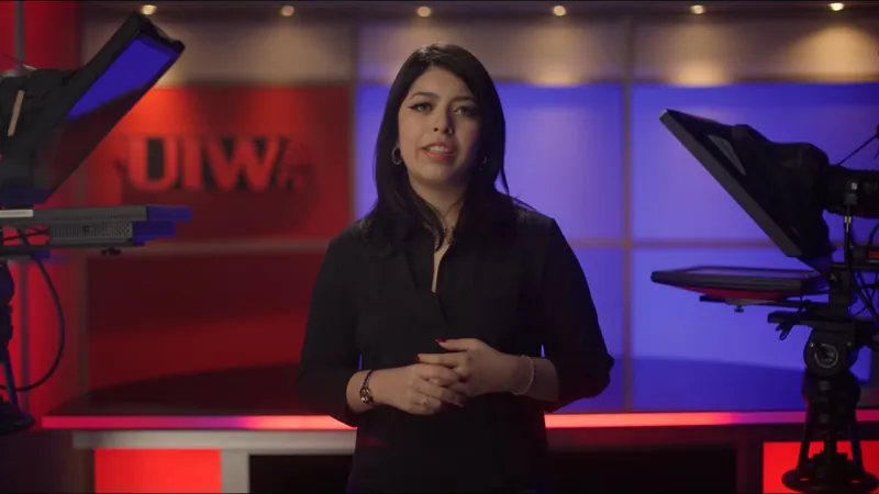 Isabel Lara stands on a UIW television studio set in her SAMMinistries Journeys of Hope story.
