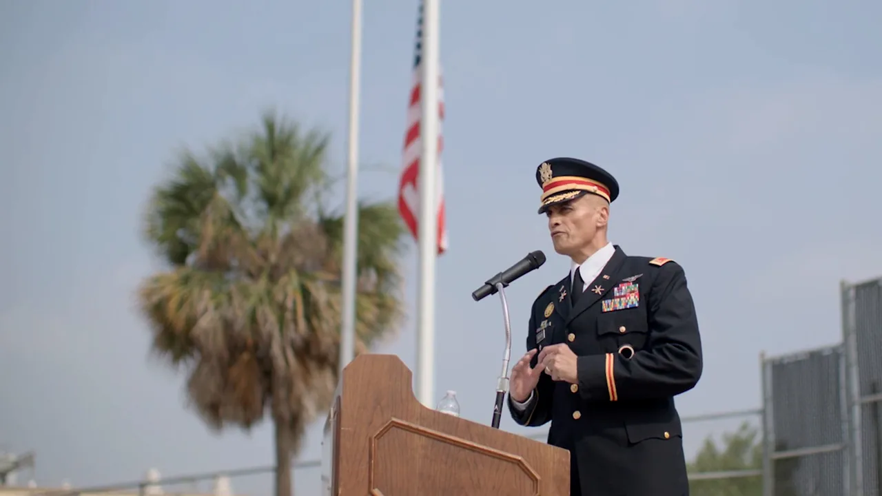 An Army officer in dress uniform speaks at a podium during the Edgewood ISD Memorial Day ceremony at Veterans Stadium.