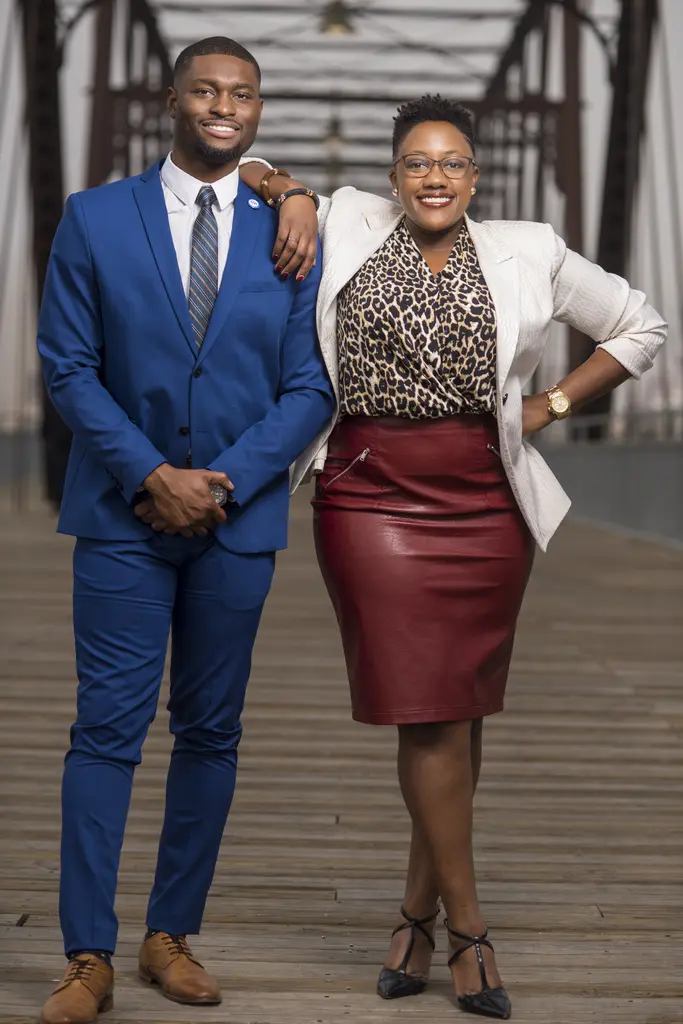 Uche Ogba and Christian Reed-Ogba, co-founders of BethanyEast PR & Management Consulting, on an iron truss bridge