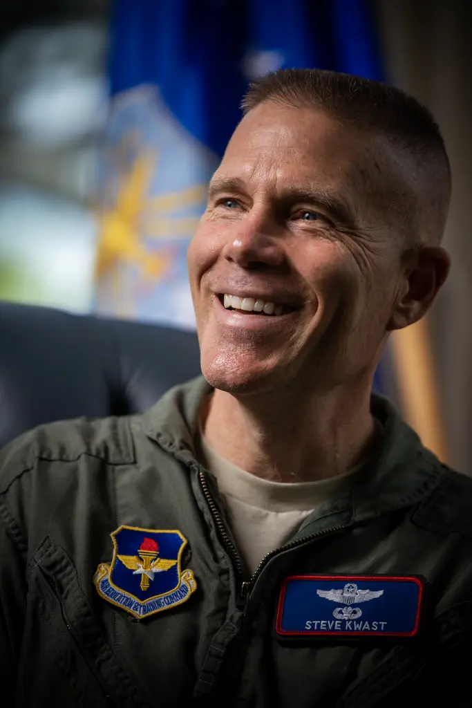 Lt. Gen. Steve Kwast smiling in an Air Force flight suit with a command patch and name tag