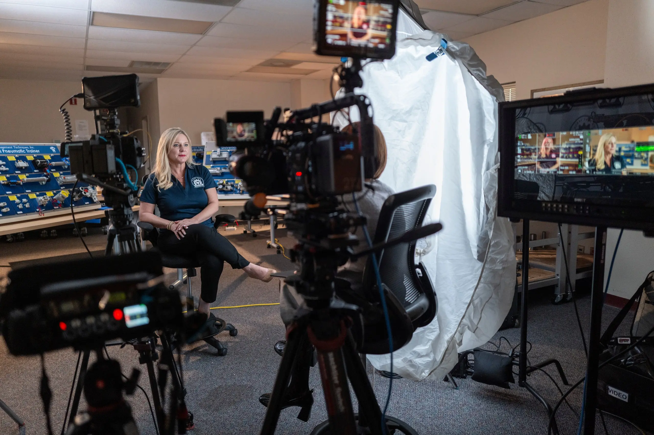 Two cinema cameras, a monitor and a white diffusion tent surround Deborah Carter of Bexar County during her TX Fast Track Program interview.