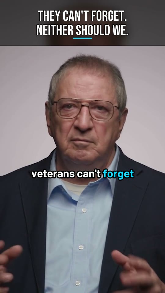 Vertical frame from the National Museum of the Pacific War Short: a man in glasses and a dark blazer, with the headline at the top and the caption at his collar.